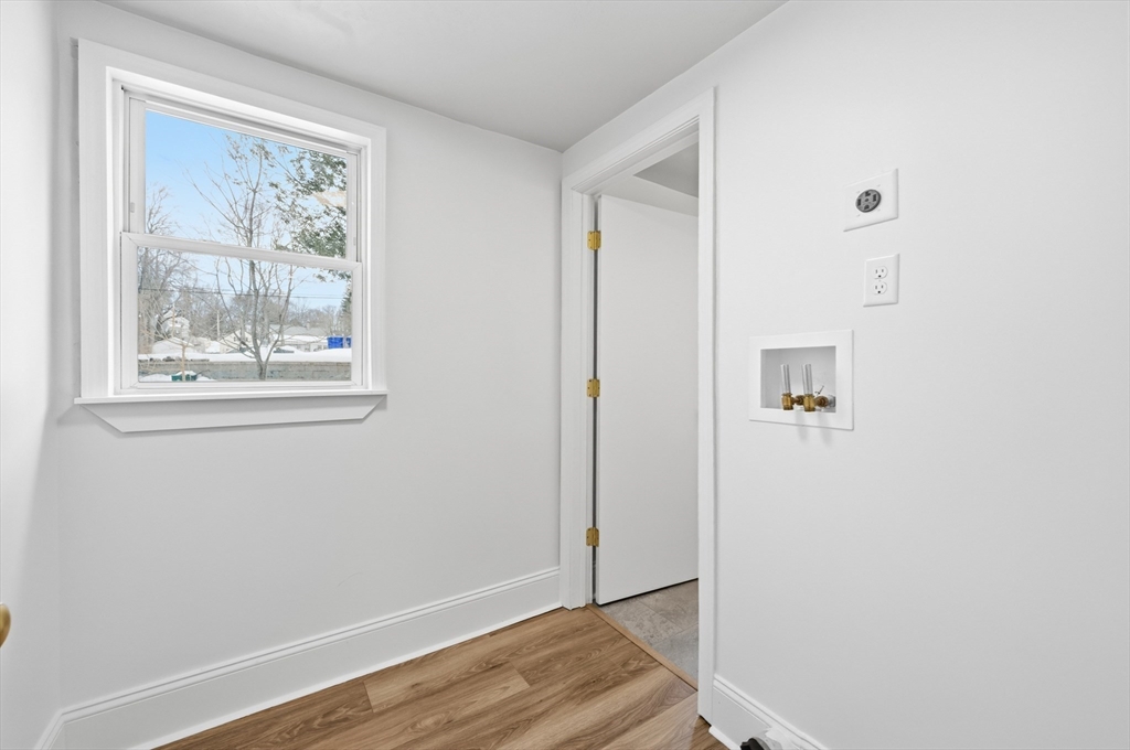 22 Douglas Avenue, Unit 1 Maynard, MA 01754 - Photo 16 of 19 a view of front door with wooden floor