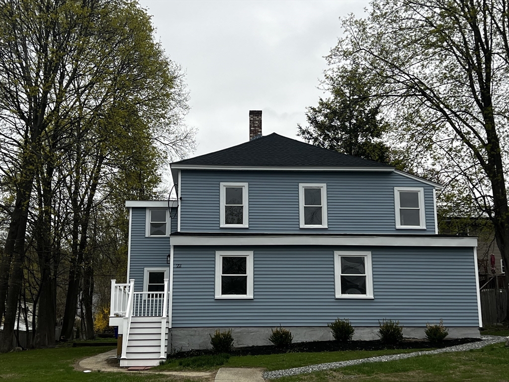 22 Douglas Avenue, Unit 1 Maynard, MA 01754 - Photo 2 of 19 a front view of a house with a yard