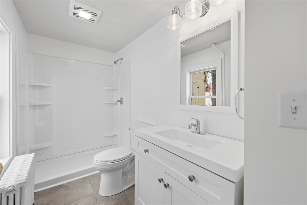 22 Douglas Avenue, Unit 1 Maynard, MA 01754 - Photo 7 of 19 a bathroom with a sink a toilet and shower