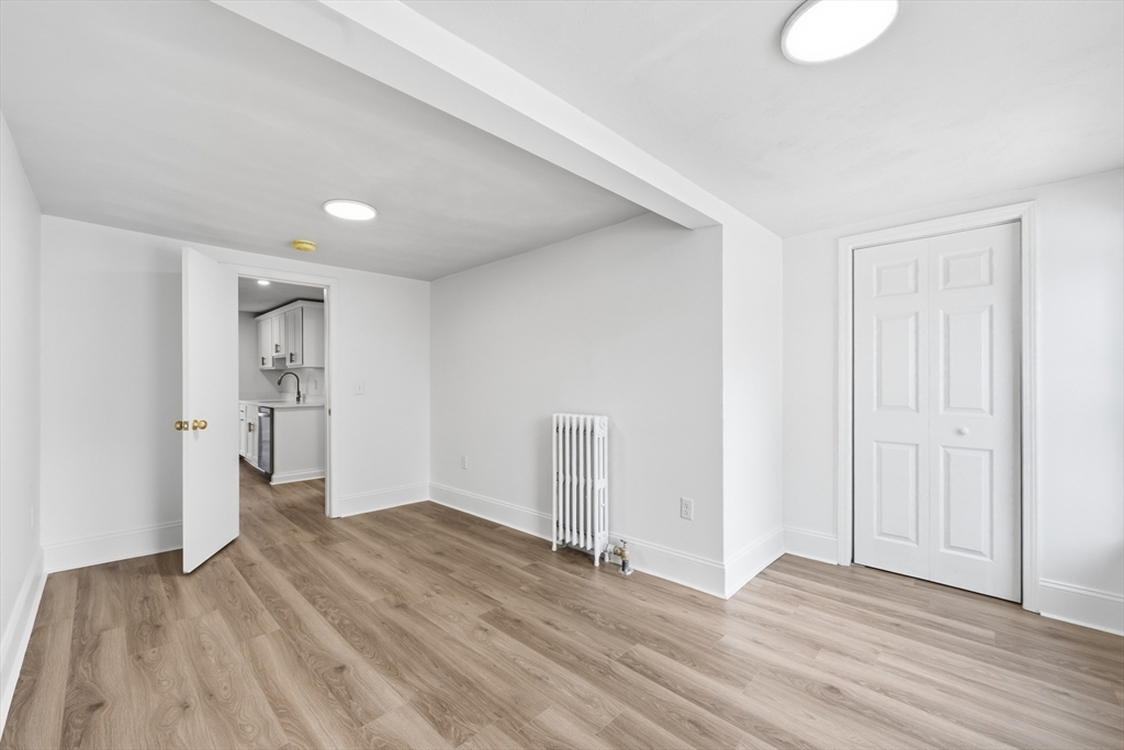 22 Douglas Avenue, Unit 1 Maynard, MA 01754 - Photo 8 of 19 wooden floor in an empty room with a window