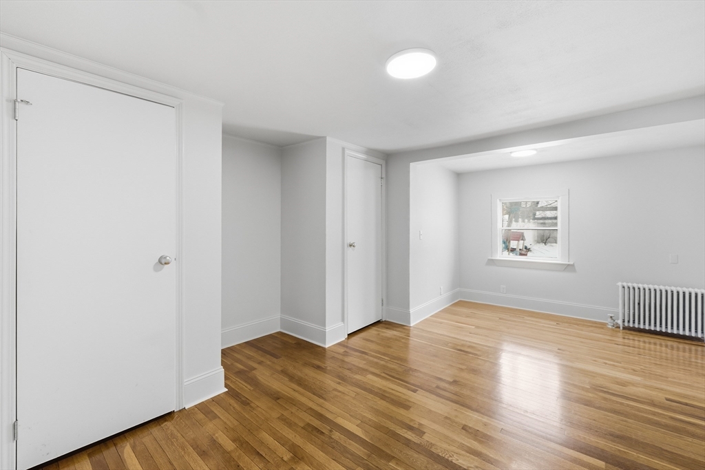 22 Douglas Avenue, Unit 1 Maynard, MA 01754 - Photo 10 of 19 a view of empty room with wooden floor