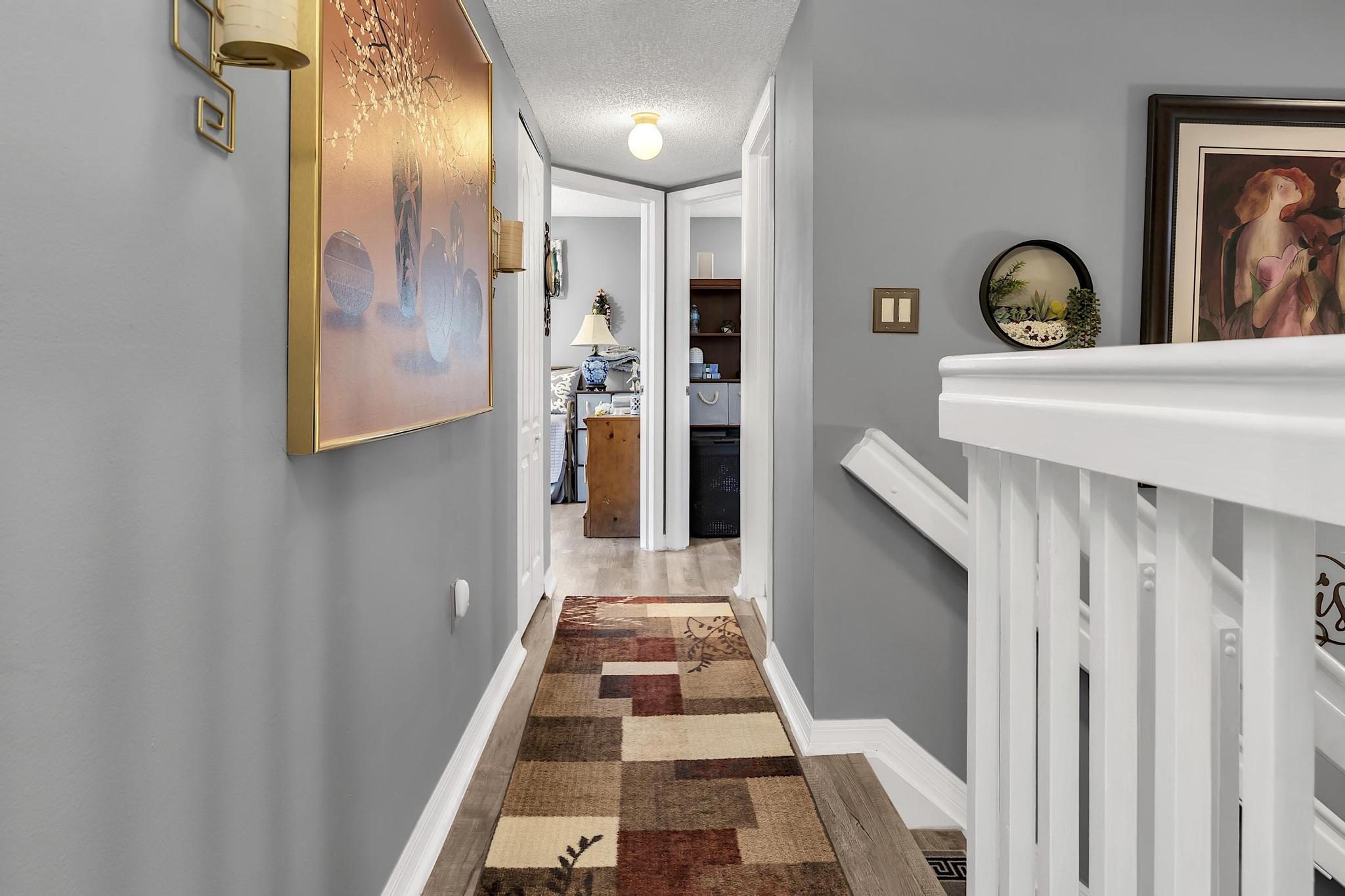 16637 Northwest 73rd Place Miami Lakes, FL 33014 - Photo 24 of 42 a hallway with painting on the wall and a mirror