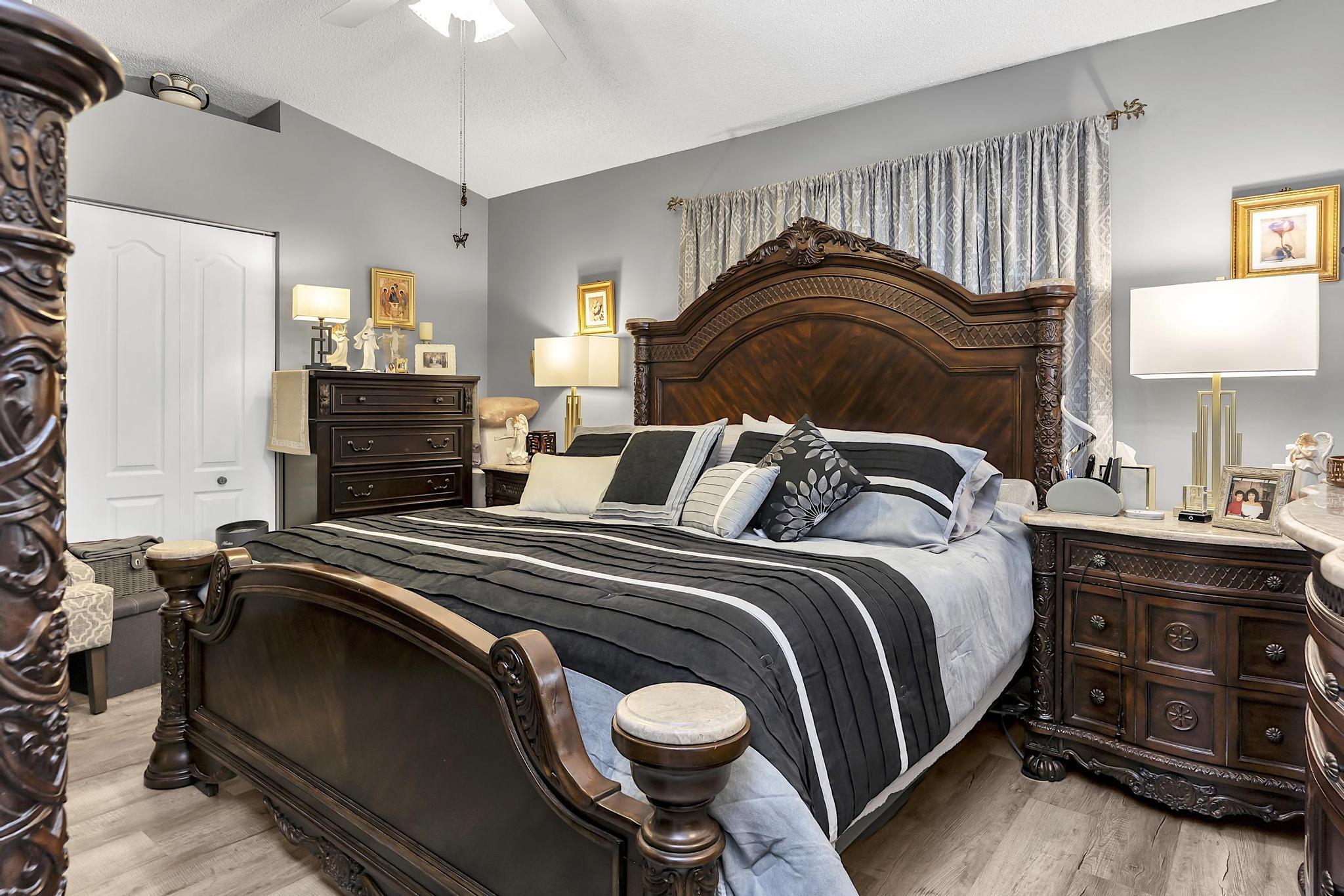 16637 Northwest 73rd Place Miami Lakes, FL 33014 - Photo 27 of 42 a bedroom with a bed and dresser