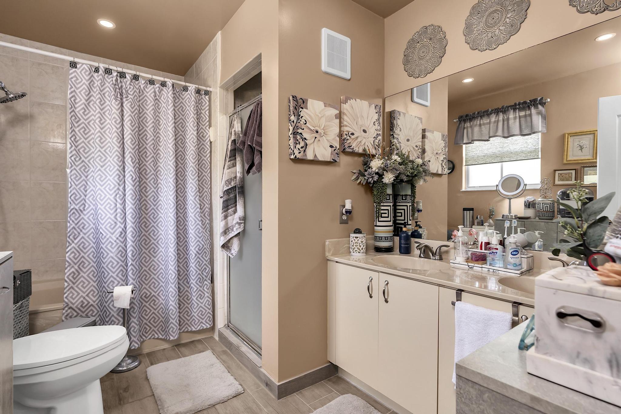 16637 Northwest 73rd Place Miami Lakes, FL 33014 - Photo 28 of 42 a bathroom with a sink a toilet and shower curtain