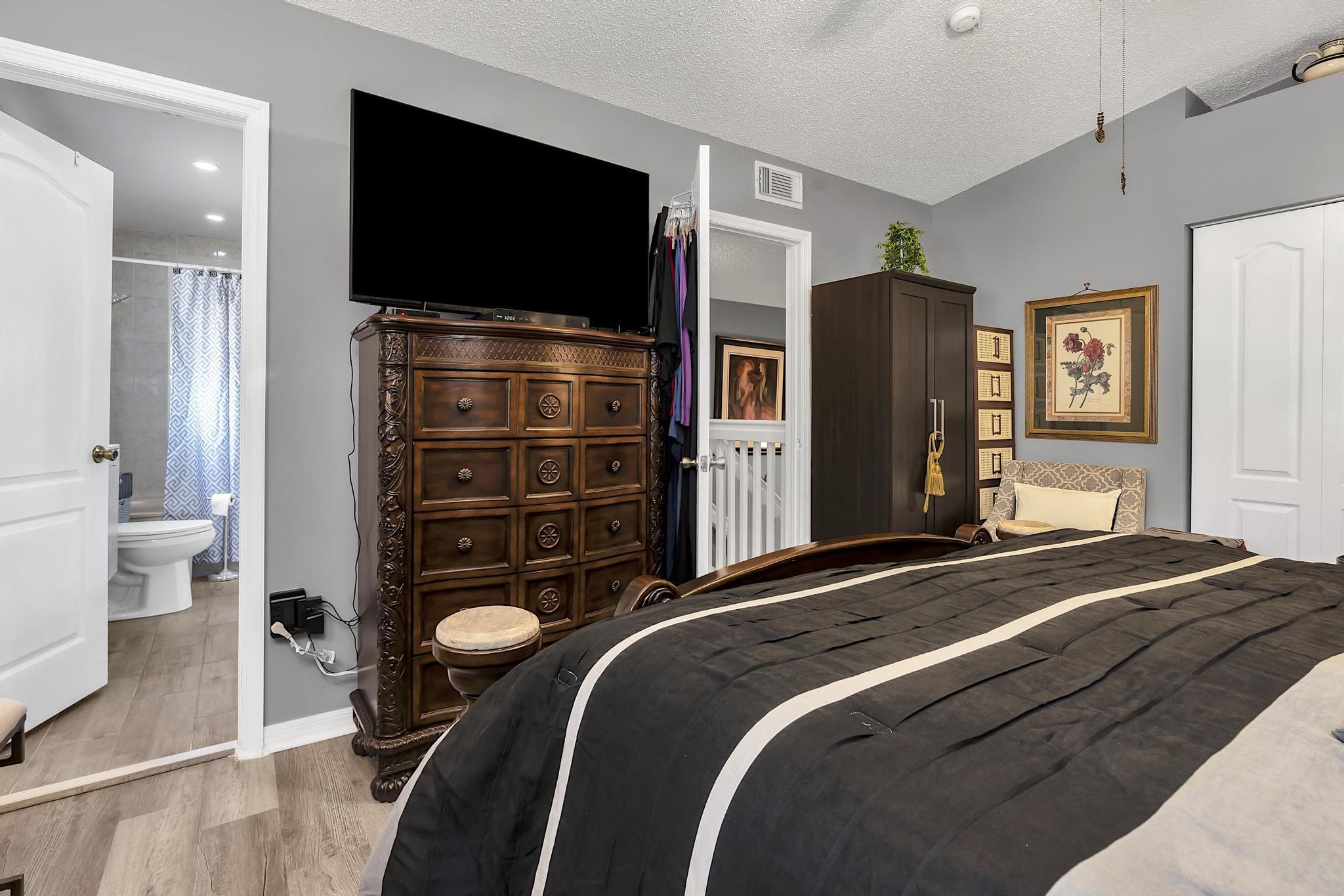 16637 Northwest 73rd Place Miami Lakes, FL 33014 - Photo 29 of 42 a bedroom with a bed and a flat screen tv