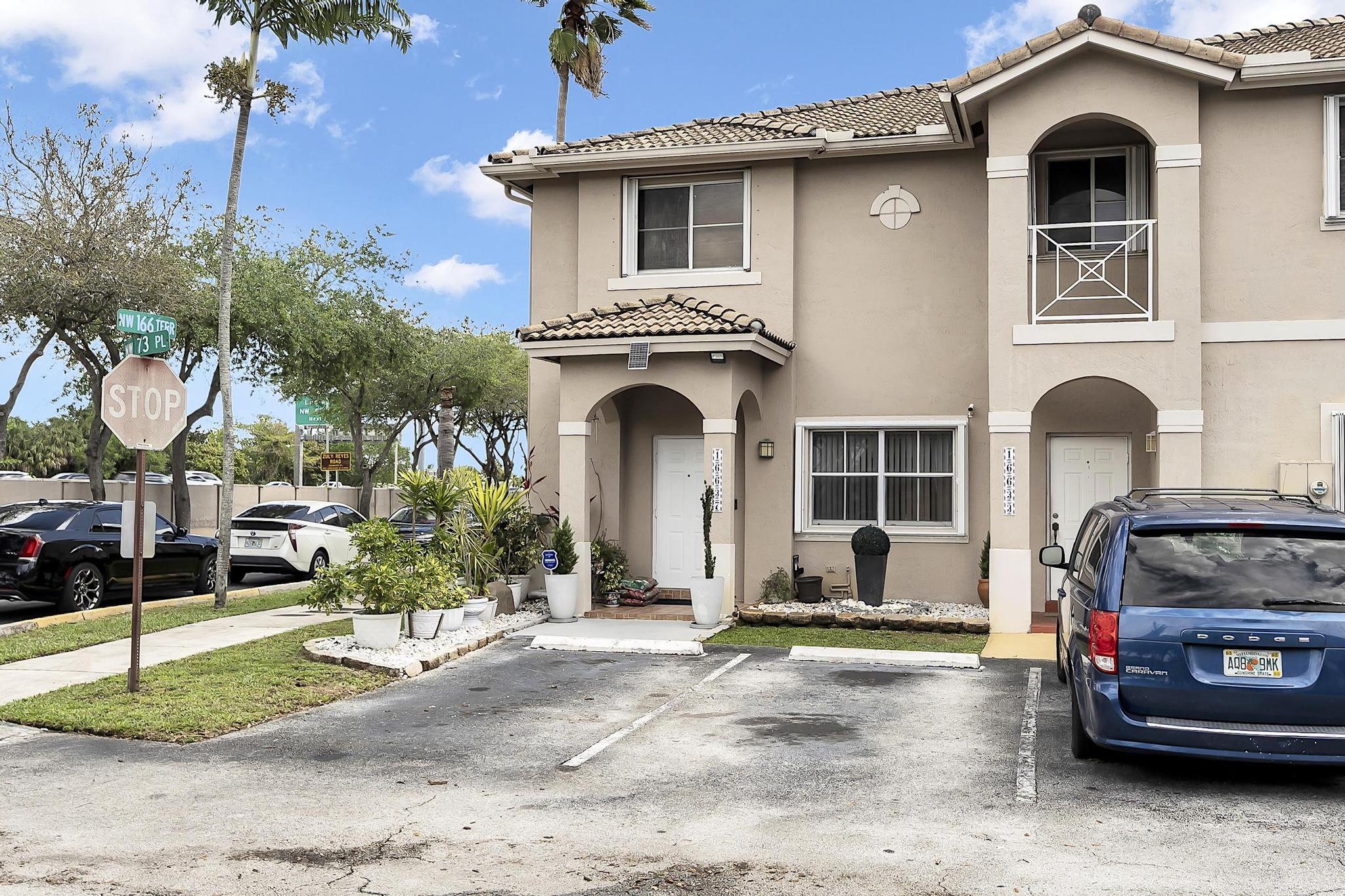 16637 Northwest 73rd Place Miami Lakes, FL 33014 - Photo 3 of 42 a front view of a house with a yard