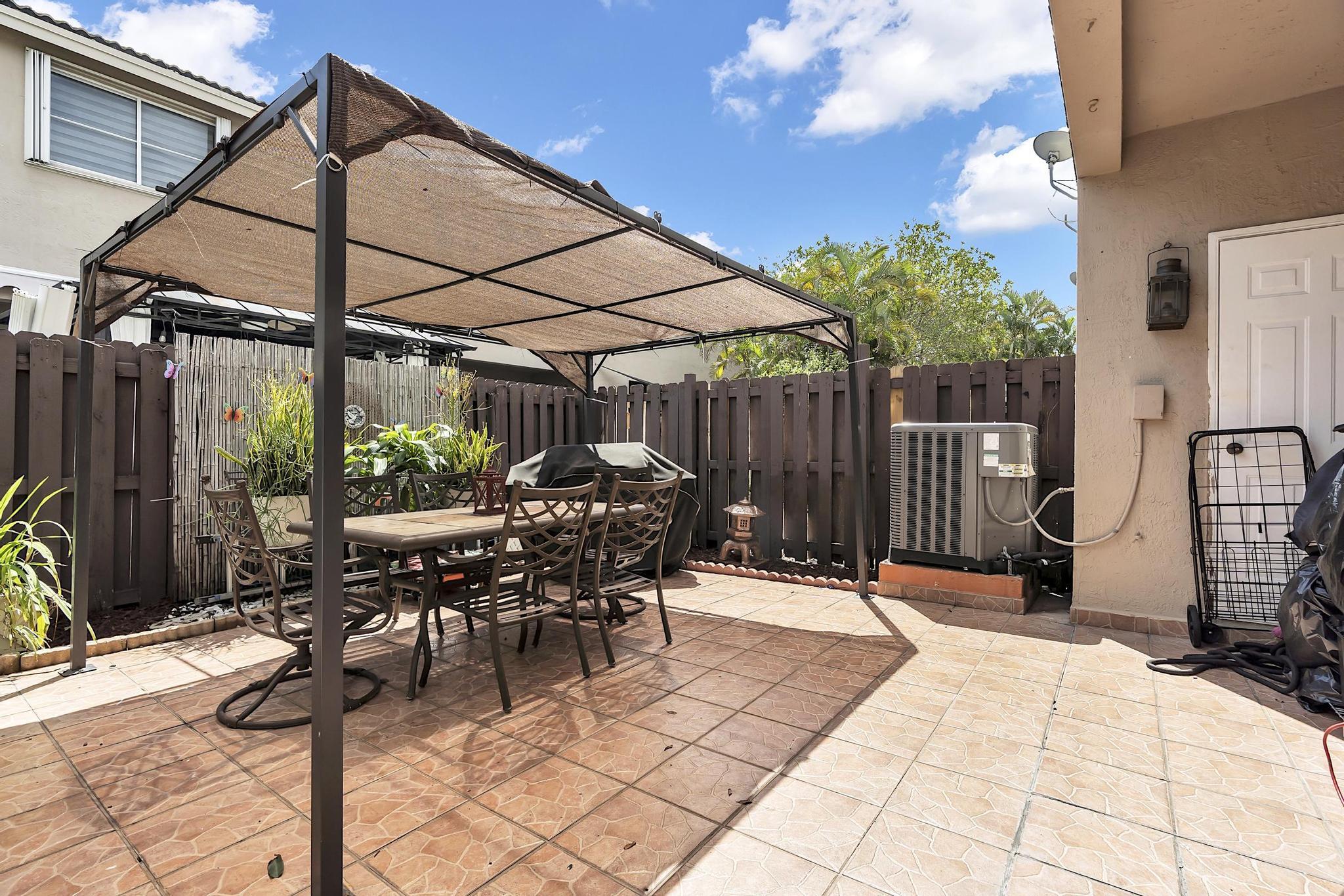 16637 Northwest 73rd Place Miami Lakes, FL 33014 - Photo 36 of 42 a patio with table and chairs