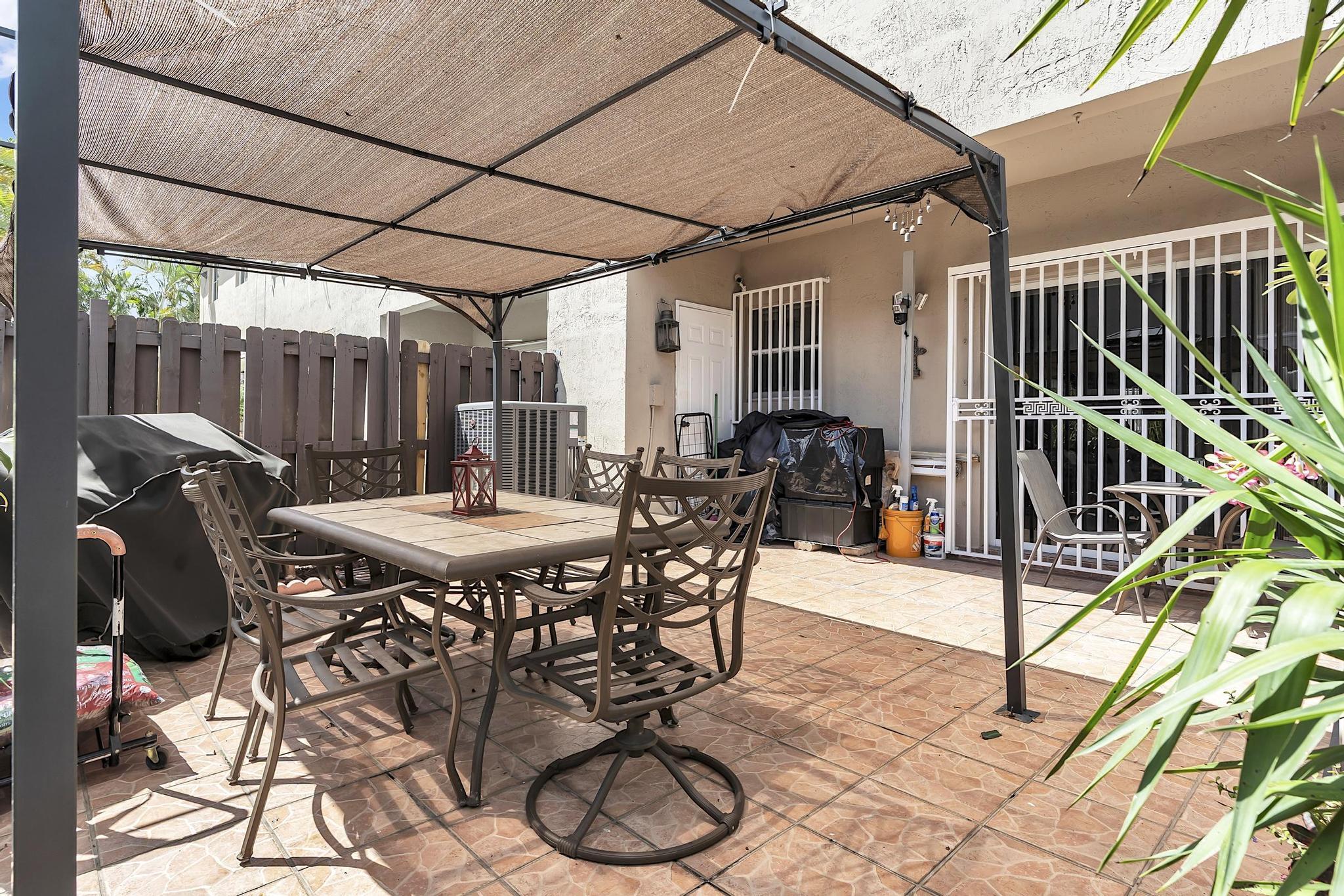 16637 Northwest 73rd Place Miami Lakes, FL 33014 - Photo 38 of 42 a table and chairs with the view of outdoor space