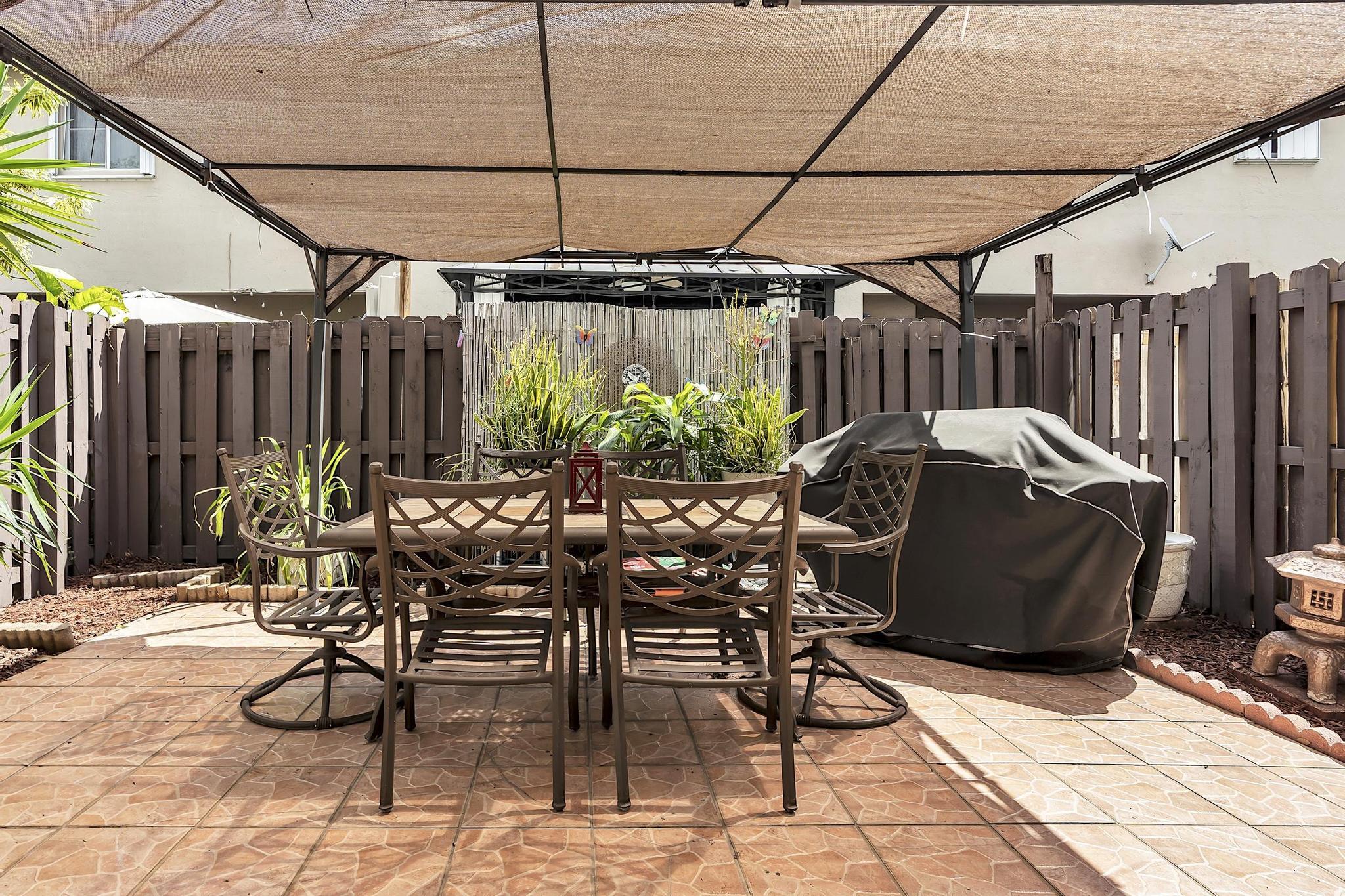 16637 Northwest 73rd Place Miami Lakes, FL 33014 - Photo 39 of 42 a view of an outdoor space with table and chairs