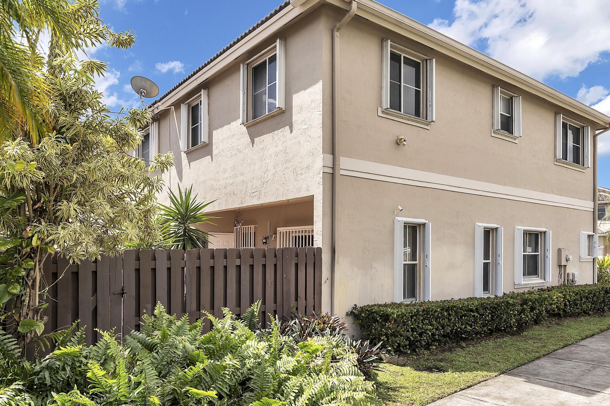 16637 Northwest 73rd Place Miami Lakes, FL 33014 - Photo 40 of 42 a front view of a house with garden