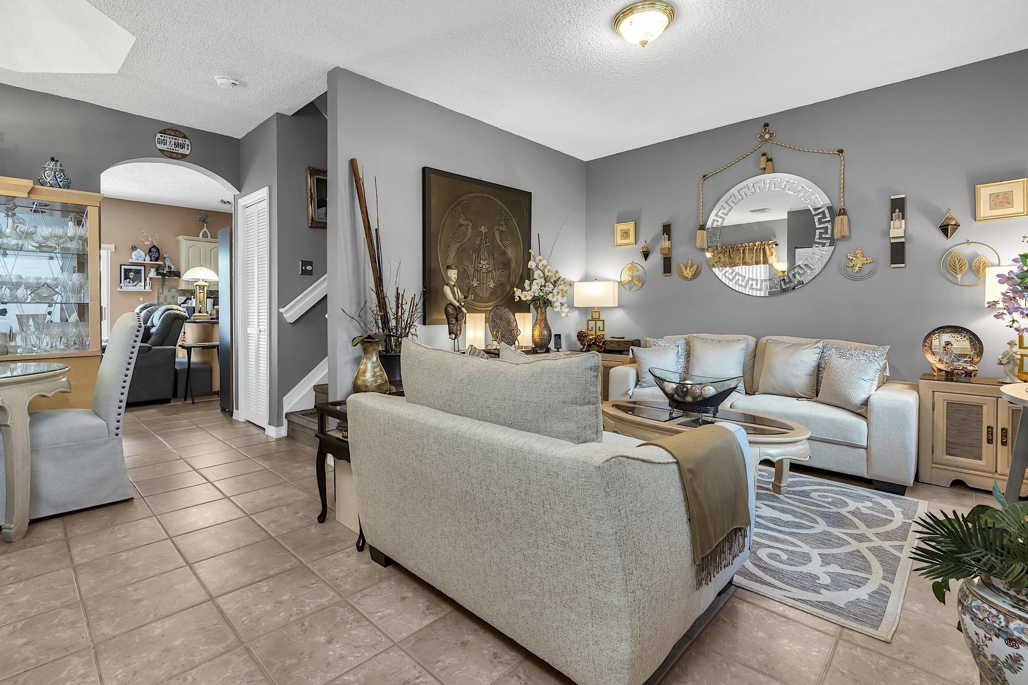 16637 Northwest 73rd Place Miami Lakes, FL 33014 - Photo 5 of 42 a living room with furniture and a chandelier