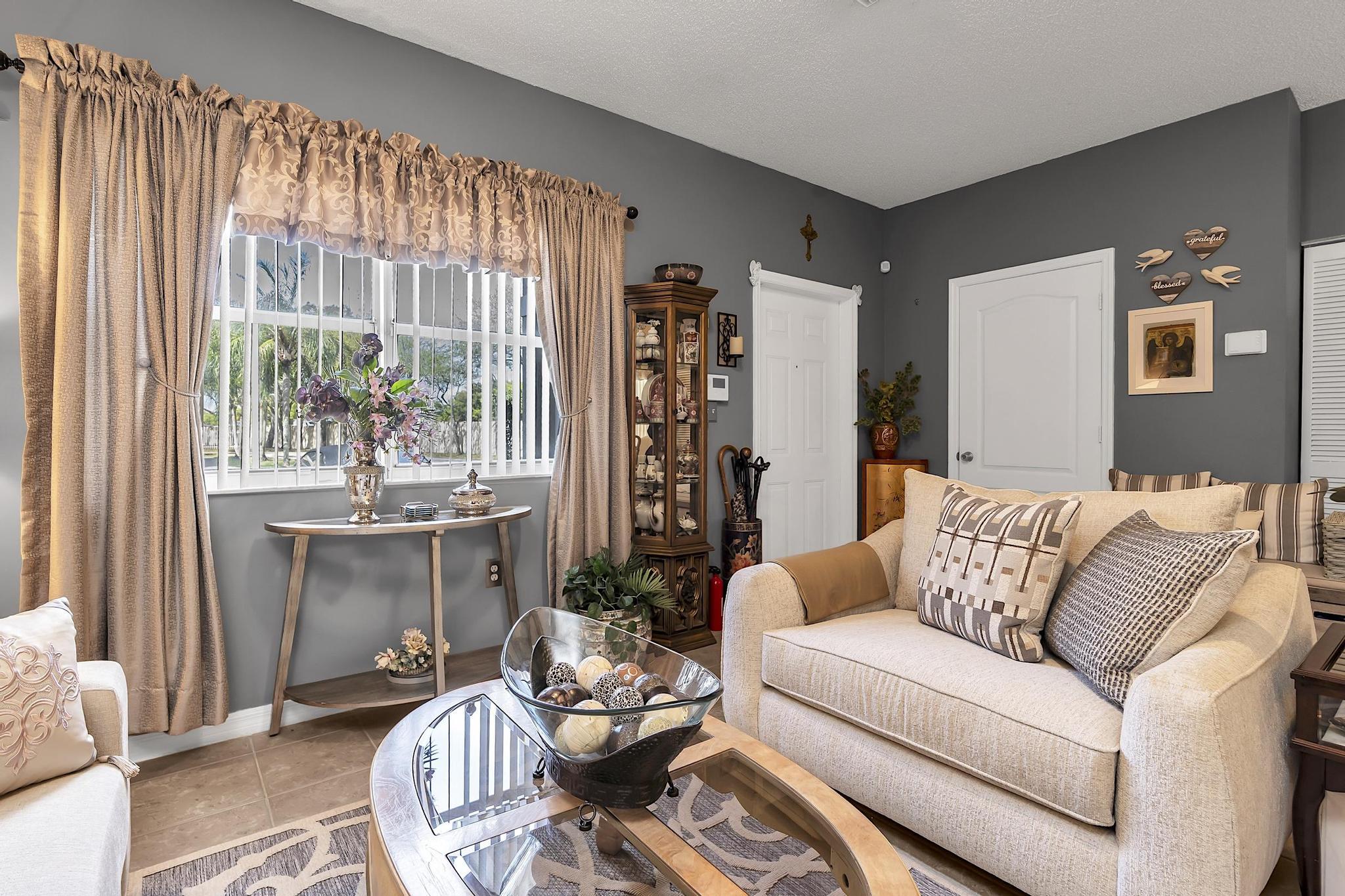 16637 Northwest 73rd Place Miami Lakes, FL 33014 - Photo 10 of 42 a living room with furniture and a large window