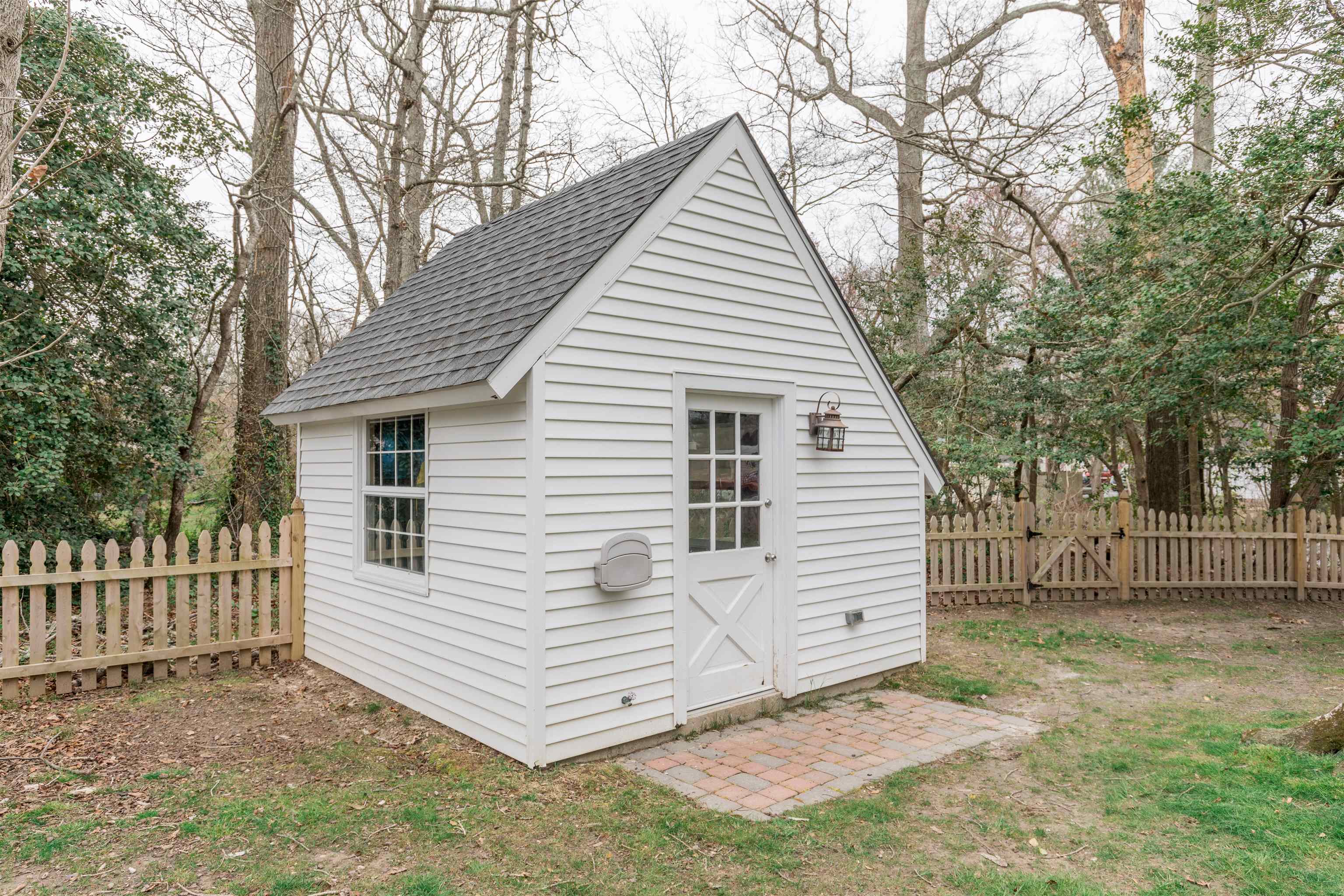970 Tecumseh Road Erma, NJ 08204 - Photo 46 of 50 a view of a white house with a large tree and wooden fence