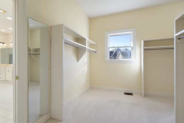 a spacious bathroom with a shower sink and mirror
