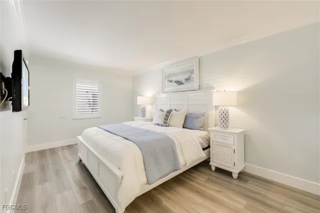 a bedroom with a bed and a painting on the wall