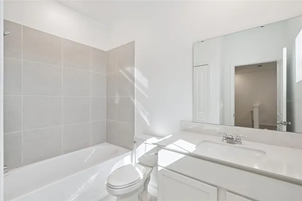 a bathroom with a sink a toilet and bathtub