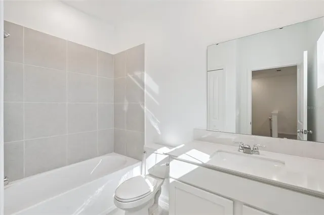 a bathroom with a sink a toilet and bathtub