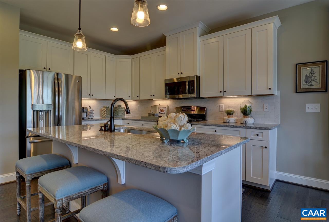 83 Ridgemont Road Ruckersville, VA 22968 - Photo 6 of 12 a kitchen with stainless steel appliances granite countertop a sink stove refrigerator and microwave