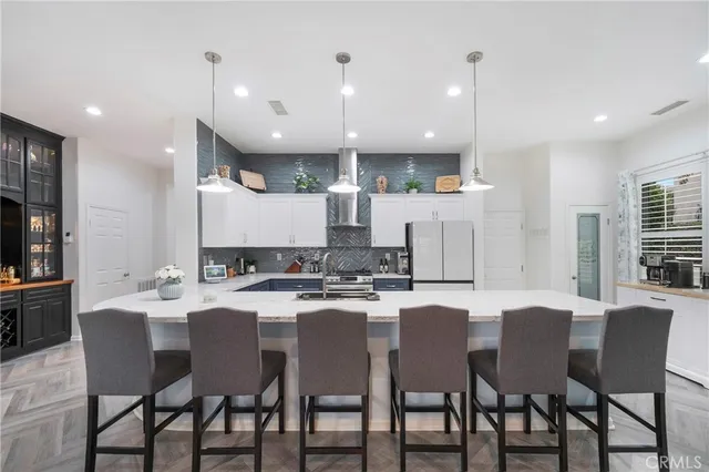 a kitchen with a dining table chairs and view kitchen