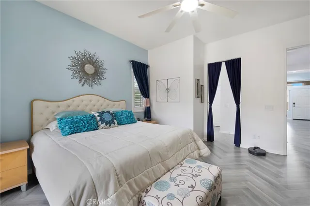 a bedroom with a large bed and a chandelier