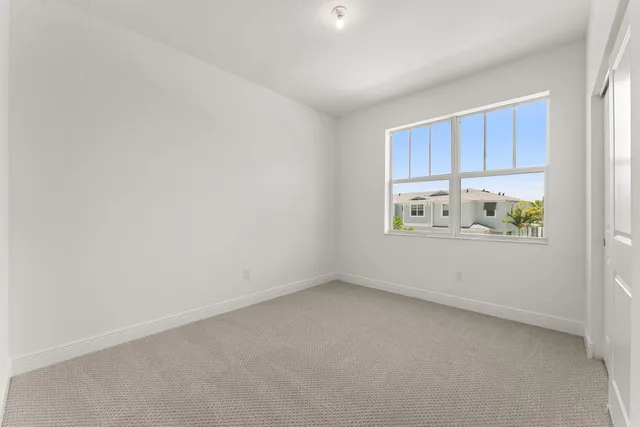 a room with a white cabinets and a window