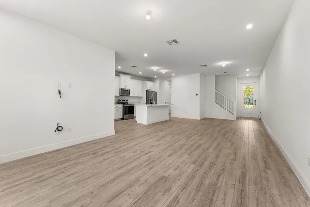 a view of a kitchen with a sink and a refrigerator