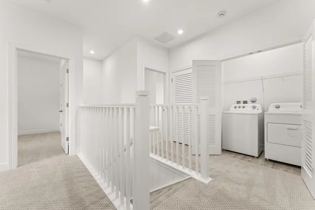 a view of a hallway with white doors