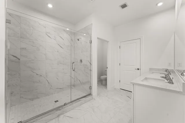 a bathroom with a shower and sink