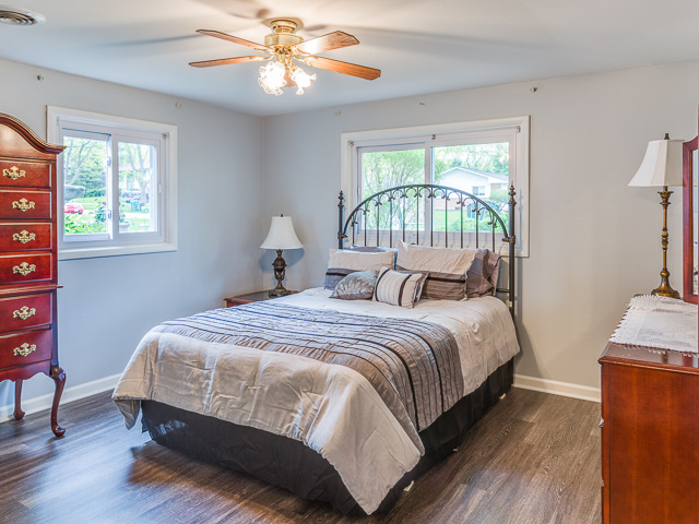 21W230 Coronet Road Lombard, IL 60148 - Photo 16 of 24 a bedroom with a bed and a chandelier