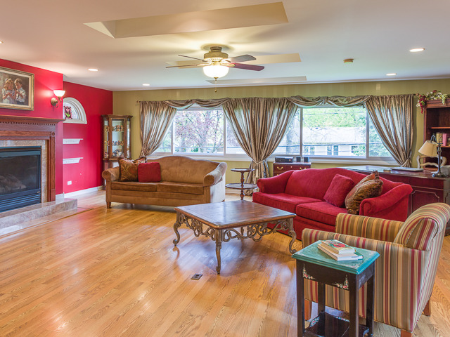 21W230 Coronet Road Lombard, IL 60148 - Photo 3 of 24 a living room with furniture a window and a fireplace