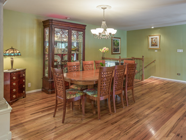 21W230 Coronet Road Lombard, IL 60148 - Photo 7 of 24 a view of a dining room with furniture a chandelier and wooden floor