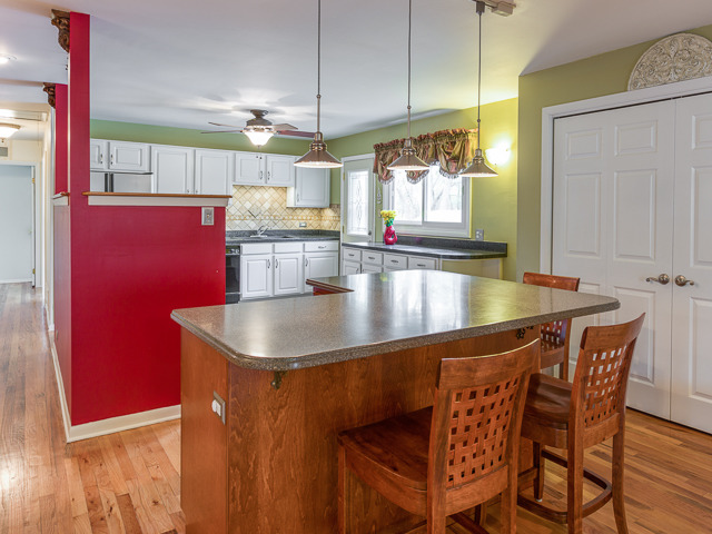 21W230 Coronet Road Lombard, IL 60148 - Photo 10 of 24 a kitchen with stainless steel appliances granite countertop a sink window and table