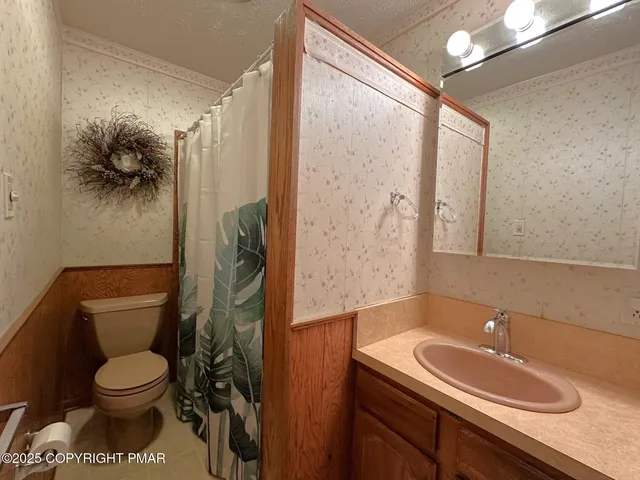 a spacious bedroom with a bed and a large mirror