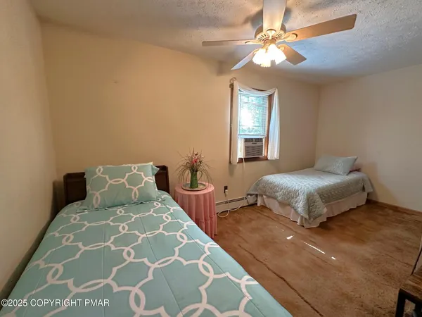 a living room with furniture a flat screen tv and windows