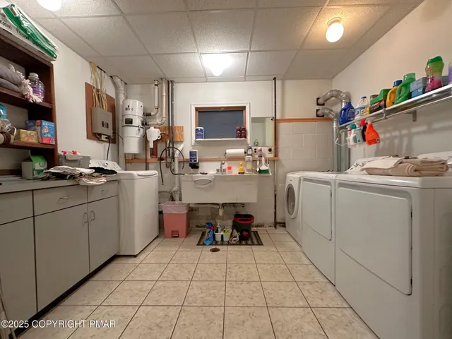 a view of a house with wooden fence and large trees