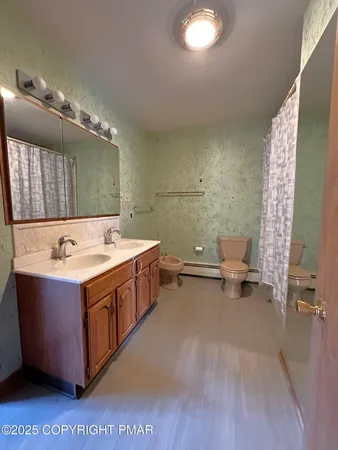 a en suite bathroom with a sink and a large mirror
