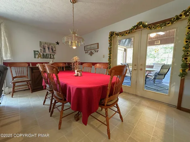 a dining room with furniture a rug and a large window