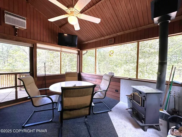 a view of a balcony with wooden floor and outdoor seating
