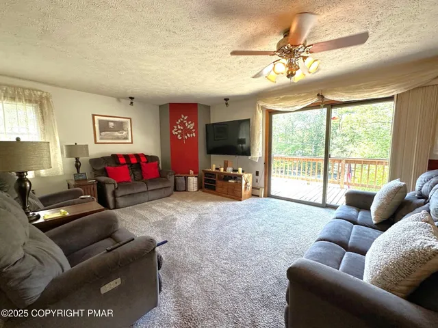 a kitchen with stainless steel appliances granite countertop a sink a stove cabinets counter space and a window