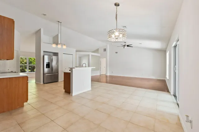 a view of a kitchen with a sink and refrigerator