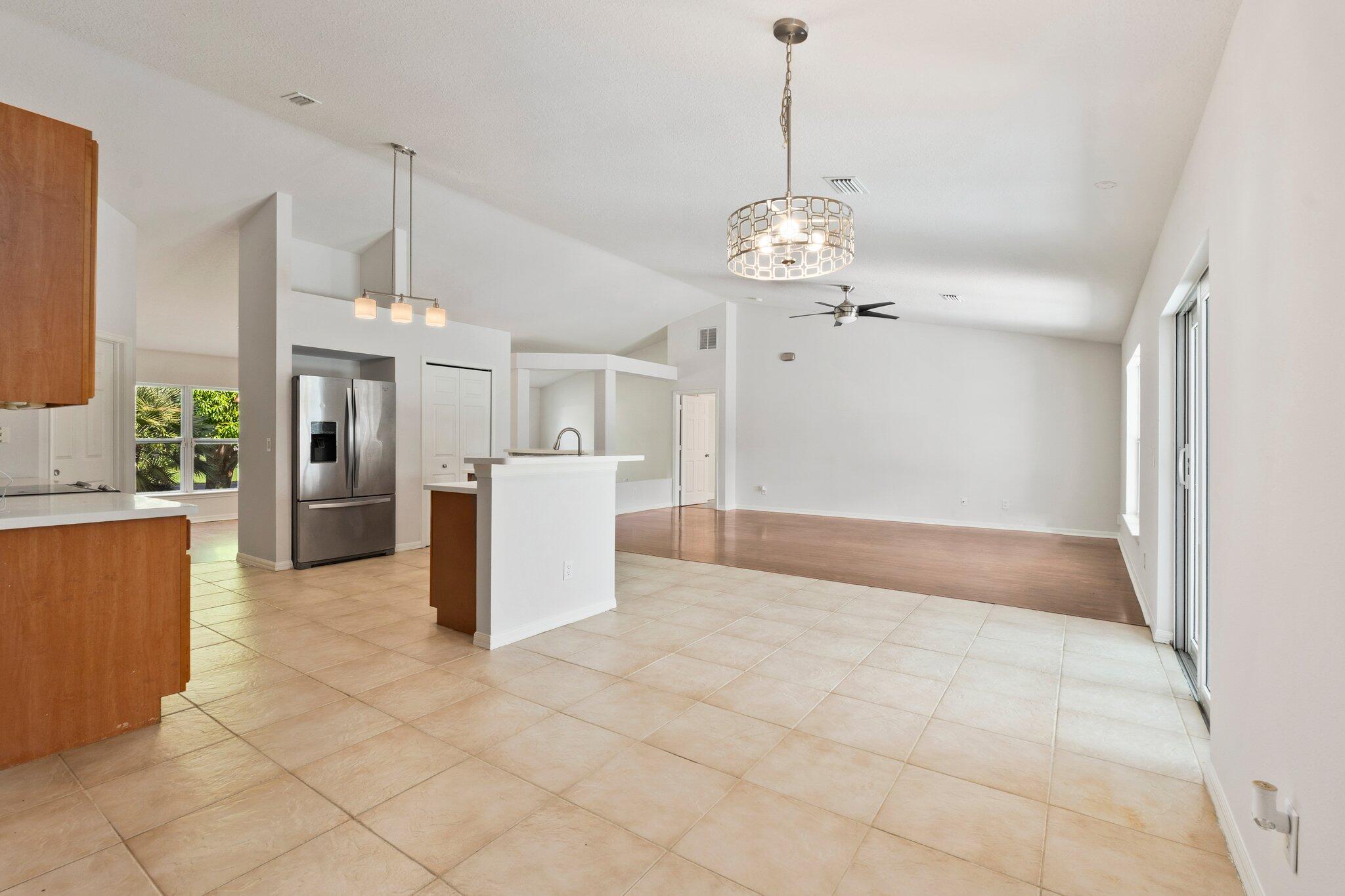 1901 Southwest Diamond Street Port St. Lucie, FL 34953 - Photo 16 of 42 a view of a kitchen with a sink and refrigerator