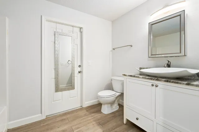 a bathroom with a toilet sink and mirror