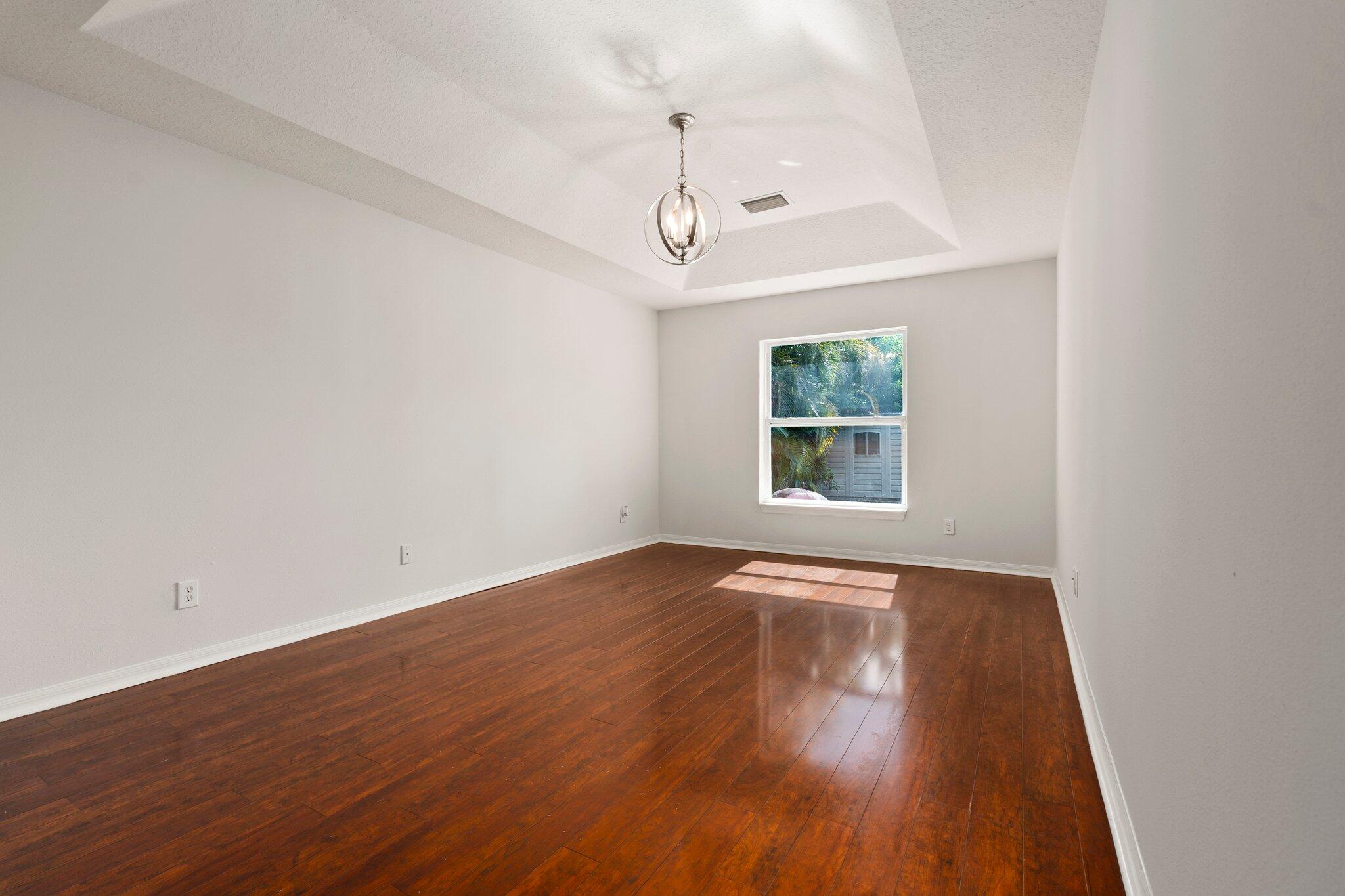1901 Southwest Diamond Street Port St. Lucie, FL 34953 - Photo 23 of 42 wooden floor in an empty room with a window
