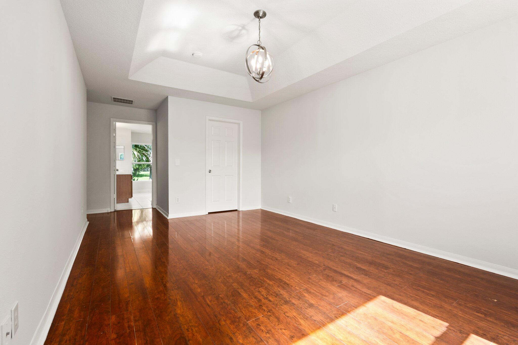 1901 Southwest Diamond Street Port St. Lucie, FL 34953 - Photo 25 of 42 a view of an empty room with wooden floor and window
