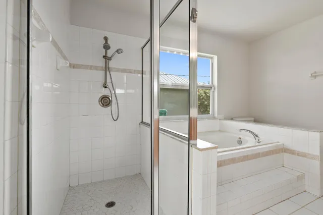 a bathroom with a tub a sink and a shower