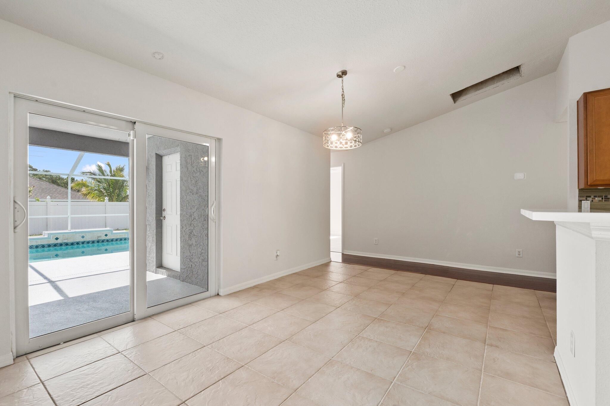 1901 Southwest Diamond Street Port St. Lucie, FL 34953 - Photo 29 of 42 a view of an empty room with glass door