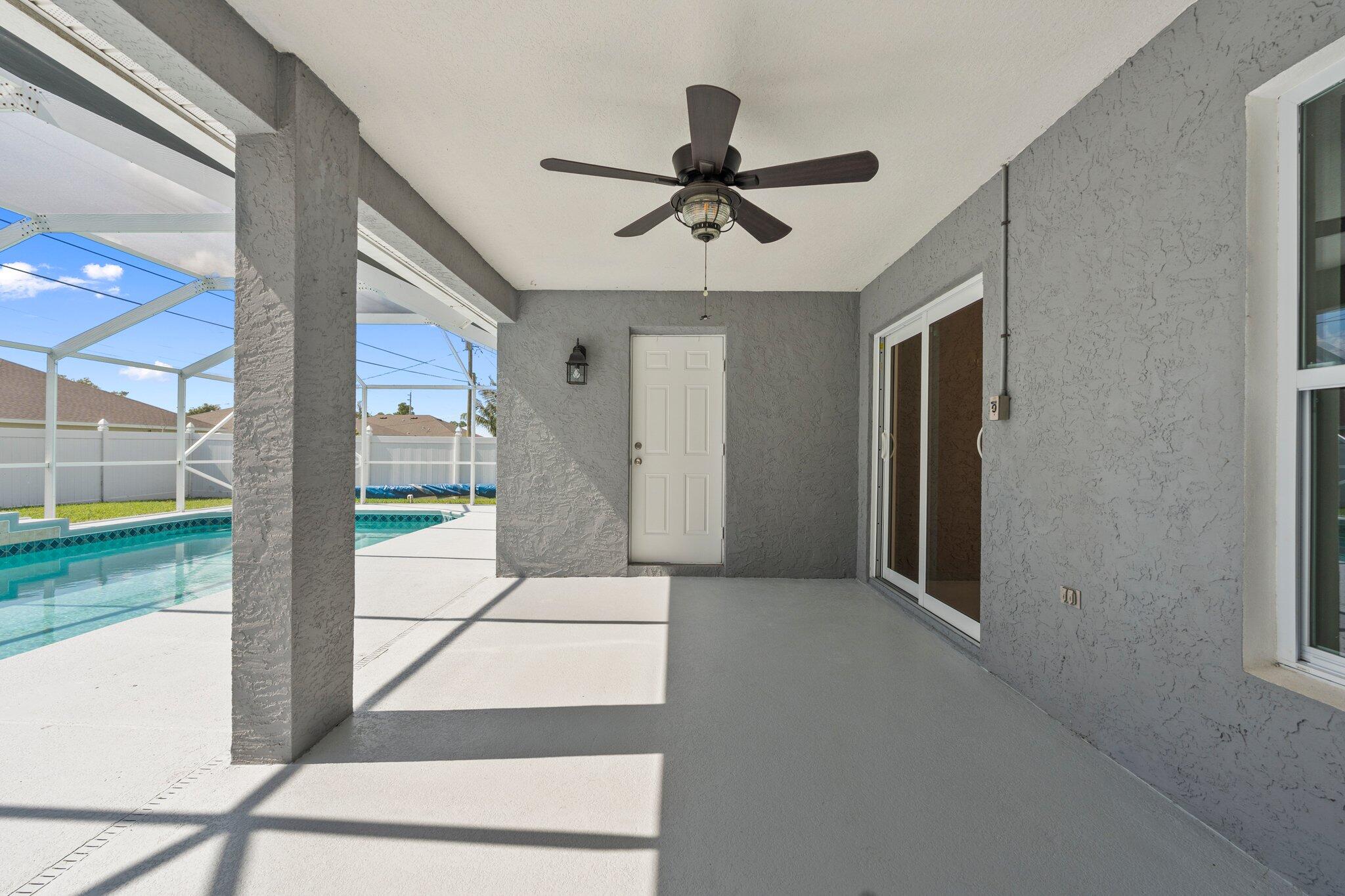 1901 Southwest Diamond Street Port St. Lucie, FL 34953 - Photo 31 of 42 a living room with a bed and a floor to ceiling window