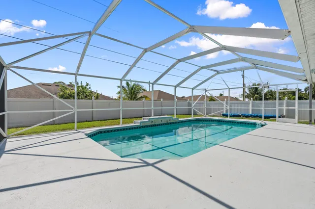 a view of a backyard with a swimming pool