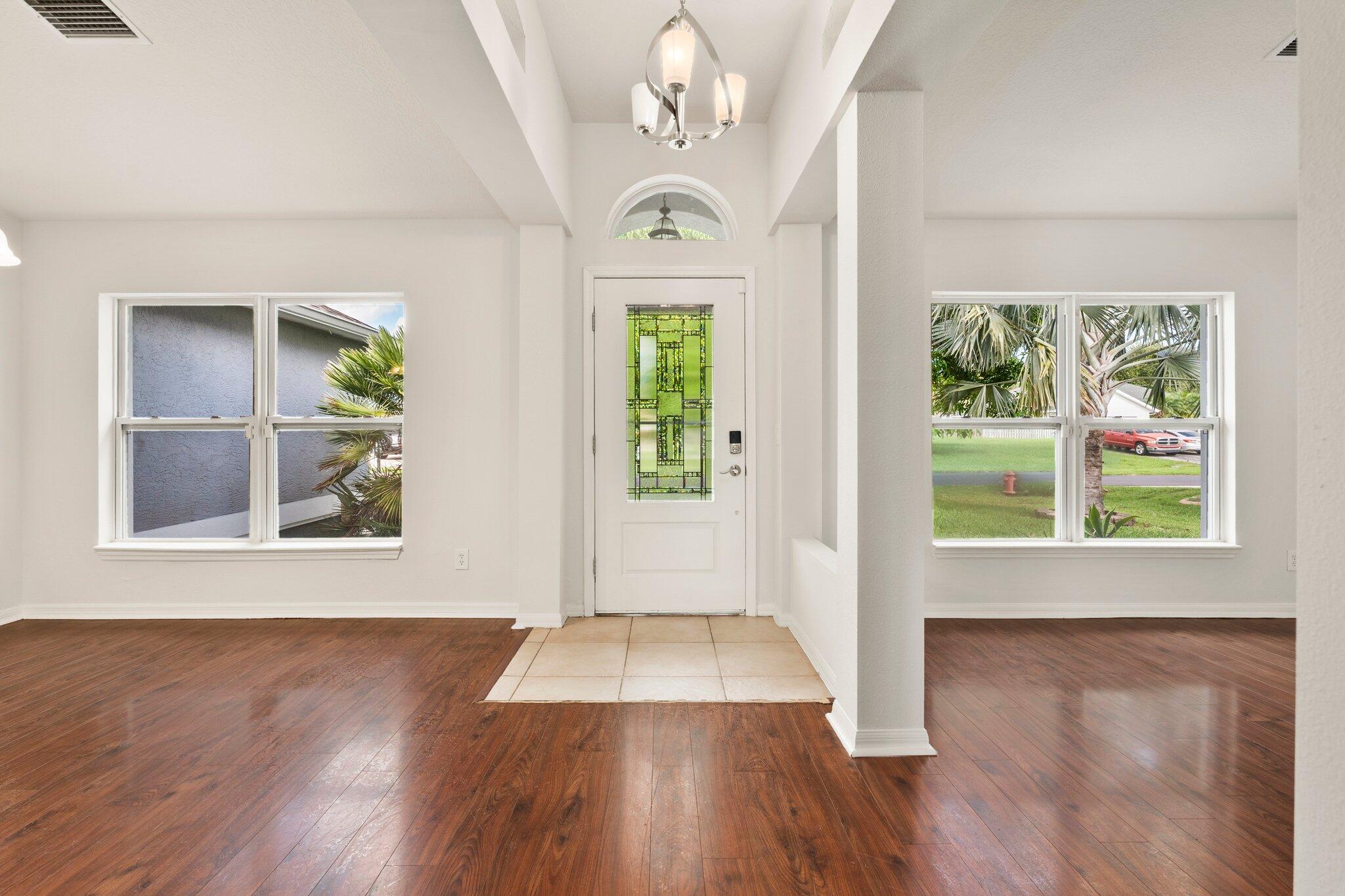 1901 Southwest Diamond Street Port St. Lucie, FL 34953 - Photo 4 of 42 a view of an entryway with wooden floor door and a window