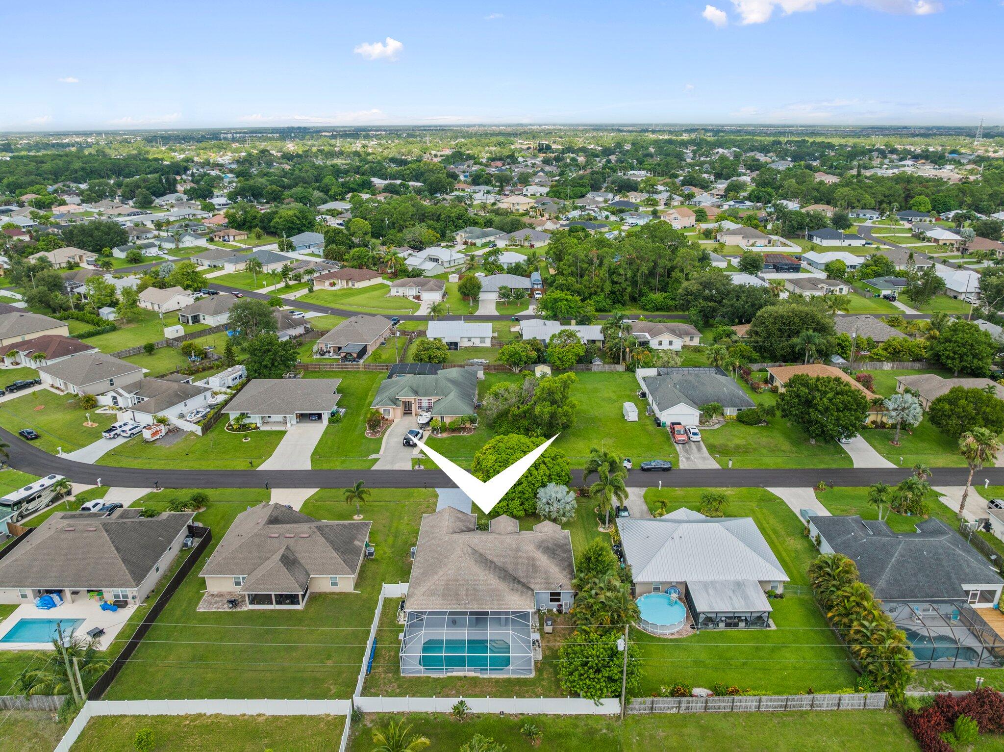 1901 Southwest Diamond Street Port St. Lucie, FL 34953 - Photo 42 of 42 an aerial view of residential houses with outdoor space and trees